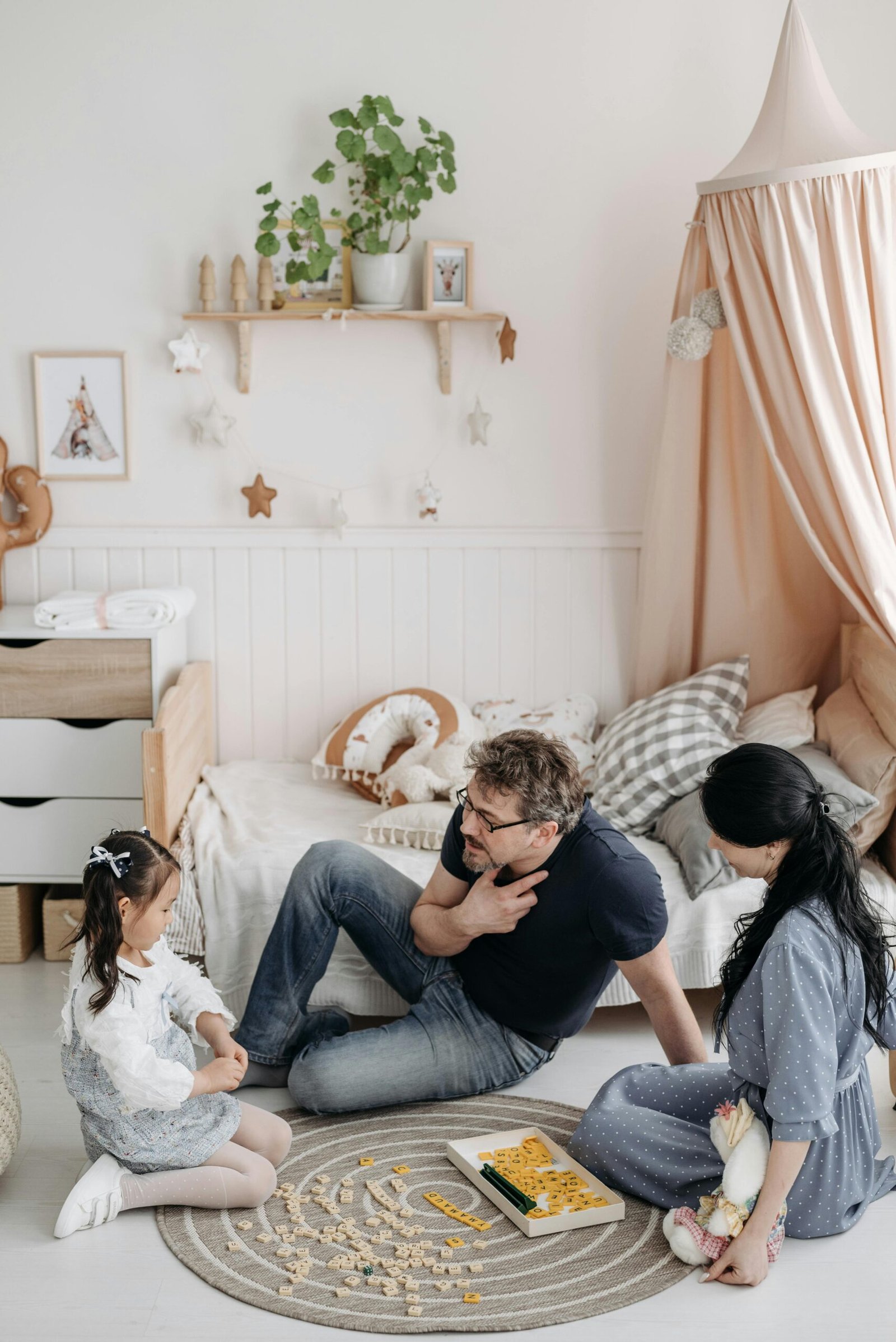 A family enjoys quality bonding time in a cozy and decorated bedroom setting.