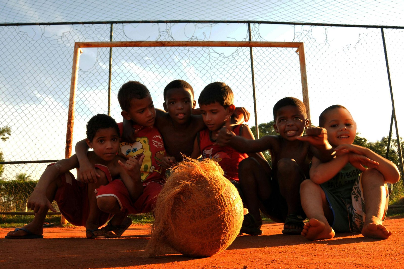 Group of kids enjoying a lively game of soccer in a Rio de Janeiro neighborhood.